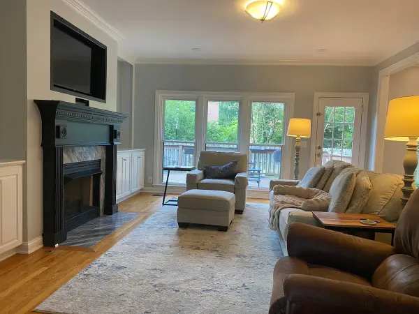 Family room with light gray walls and a black fireplace mantel, Franklin, TN