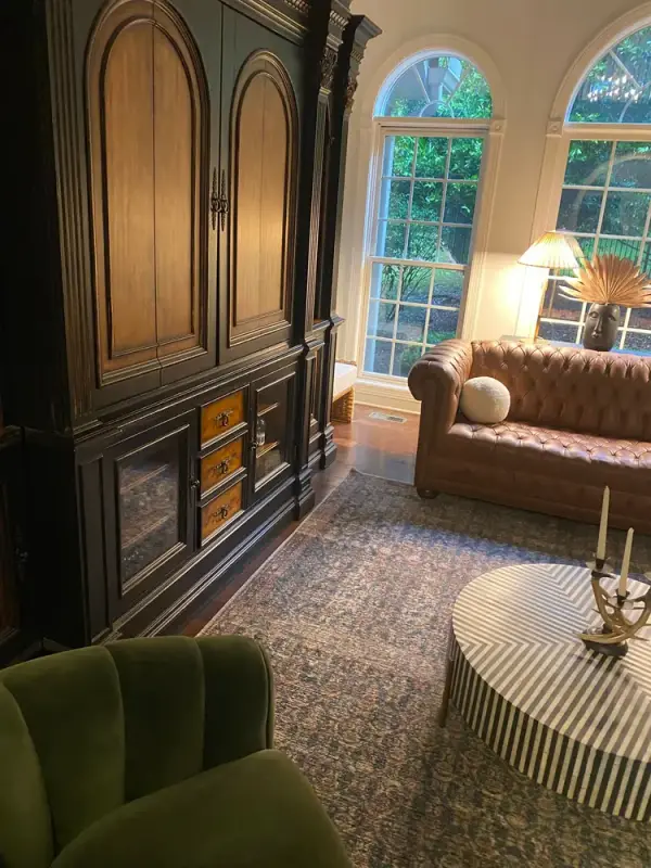 Sitting room with arched windows and a dark armoire, Franklin, TN