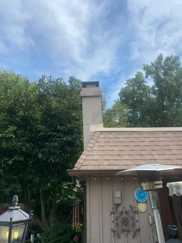 Gray siding and chimney against a cloudy sky, Franklin, TN