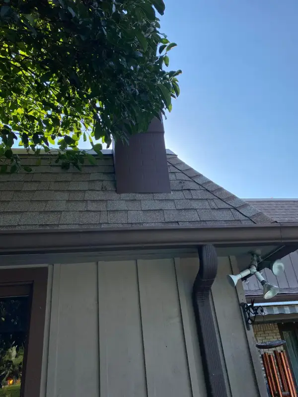 Gray board siding under a shingle roof and chimney, Franklin, TN