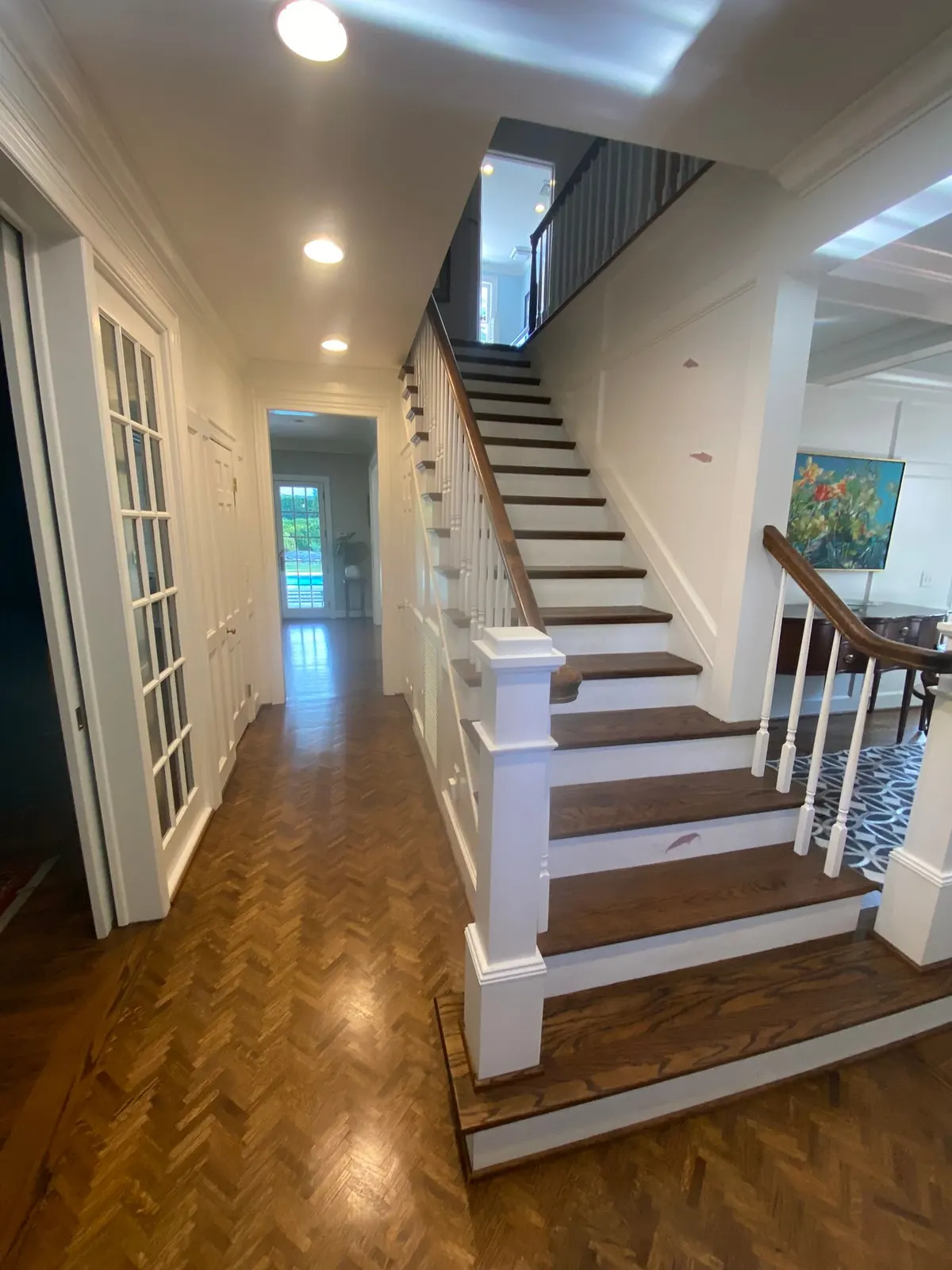 Staircase with white risers and spindles over herringbone floor, Belle Meade, TN