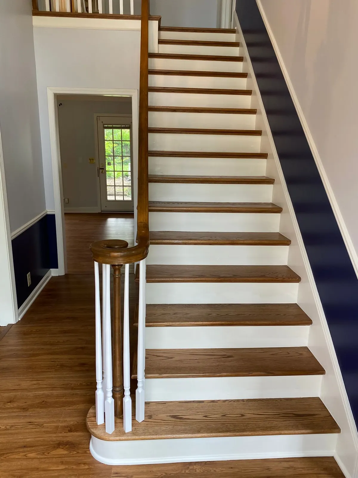 White risers and spindles with a navy band along the stair wall, Bellevue, TN