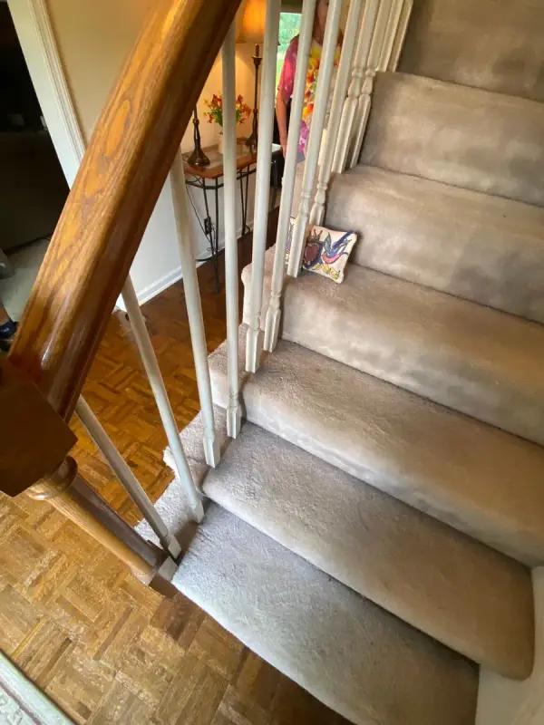 Carpeted stair with white spindles and oak handrail, Bellevue, TN