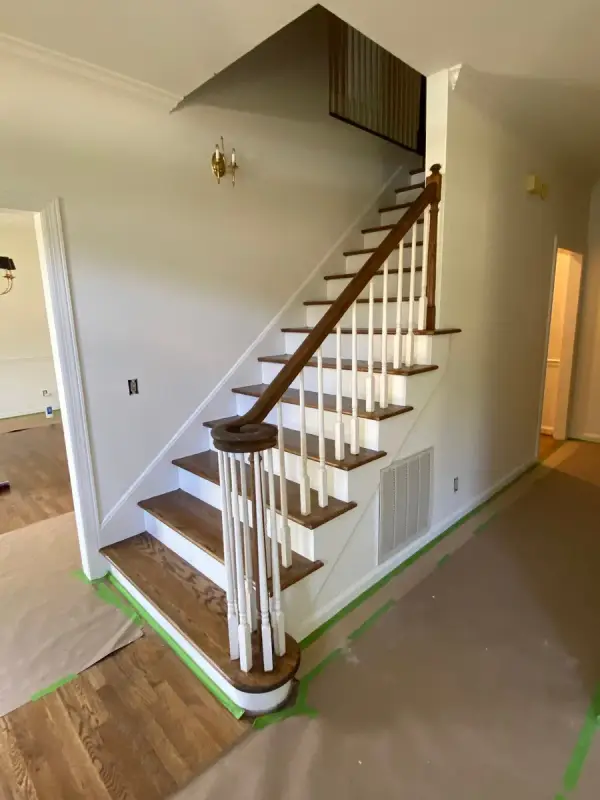 Stair with volute handrail, floor covered in paper, Bellevue, TN