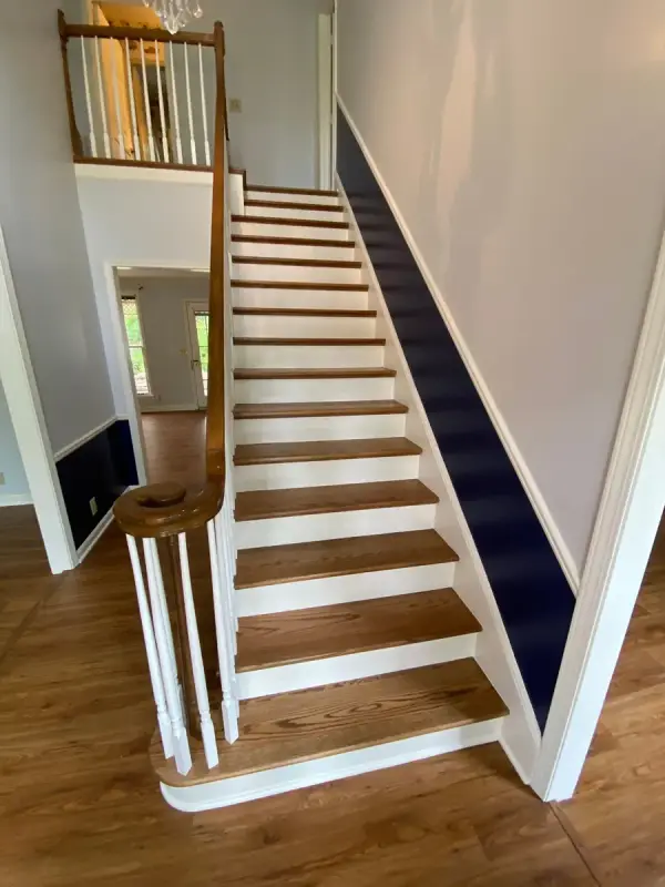 Staircase with white risers, stained treads and navy stair wall band, Bellevue, TN