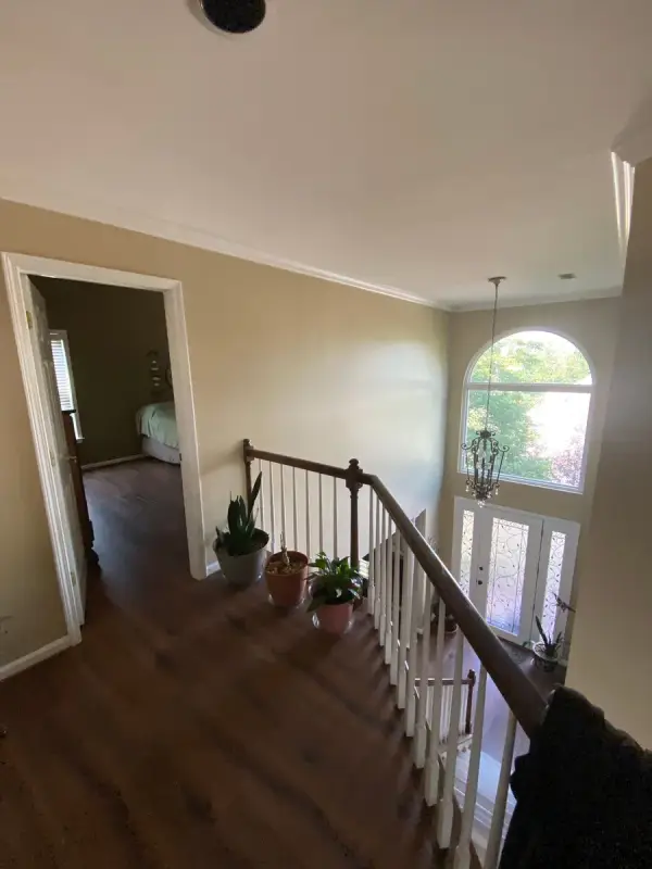 Stair landing with white spindles and tan walls, Bellevue, TN
