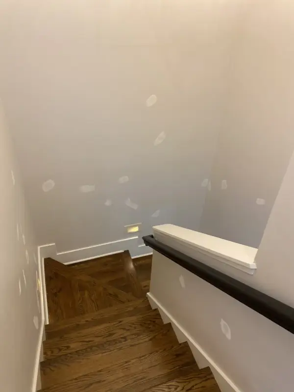 Stairwell walls with patching spots above dark treads, Brentwood, TN