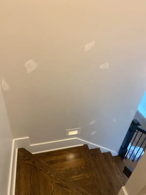 Patched stairwell wall above a dark landing, Brentwood, TN