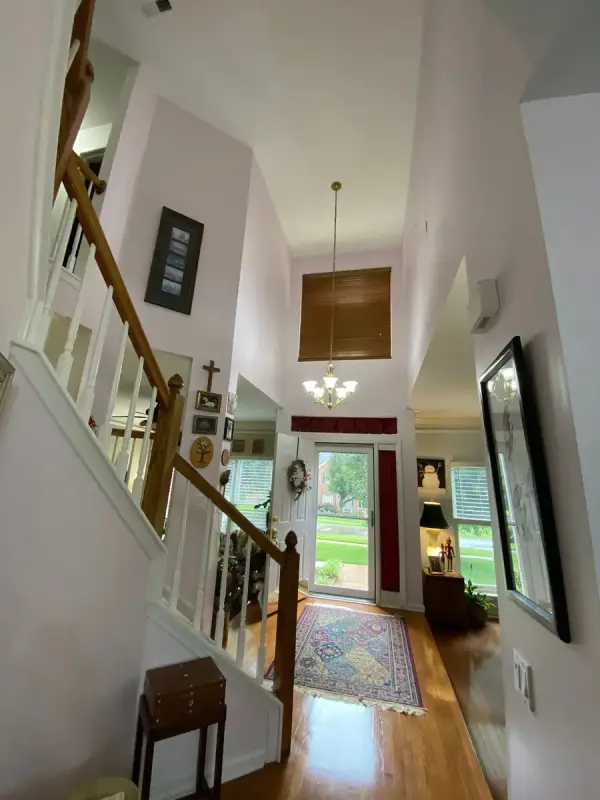 Foyer stair with white spindles and pale walls, Brentwood, TN