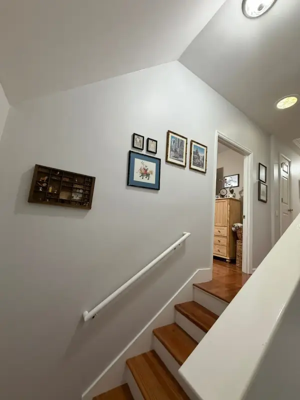 Stairwell with pale walls and a white handrail, Brentwood, TN