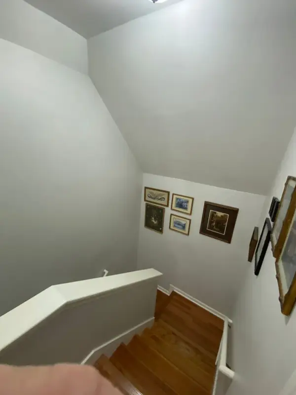 Stairwell with pale walls and white half-wall cap, Brentwood, TN