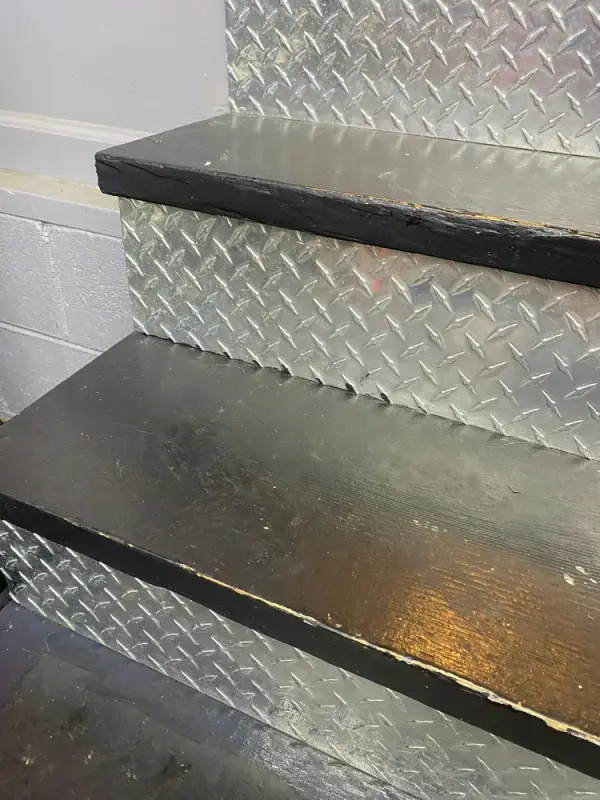 Dark painted stair treads with diamond-plate risers, close view, Franklin, TN