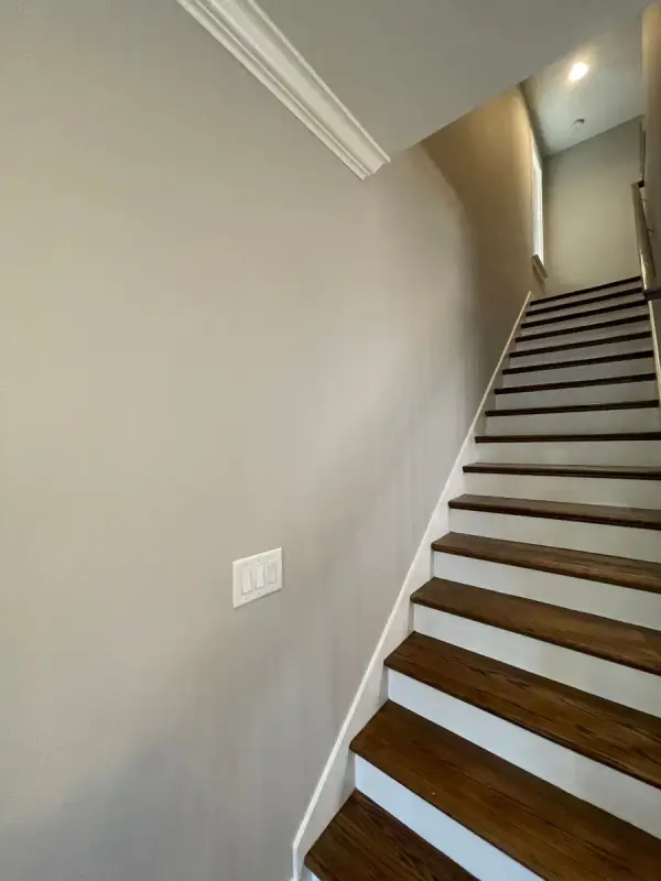 Staircase with white risers and stained treads along a gray wall, The Nations, Nashville, TN