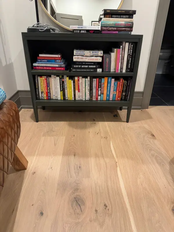 Black bookcase against white wall and dark baseboard, Belle Meade, TN