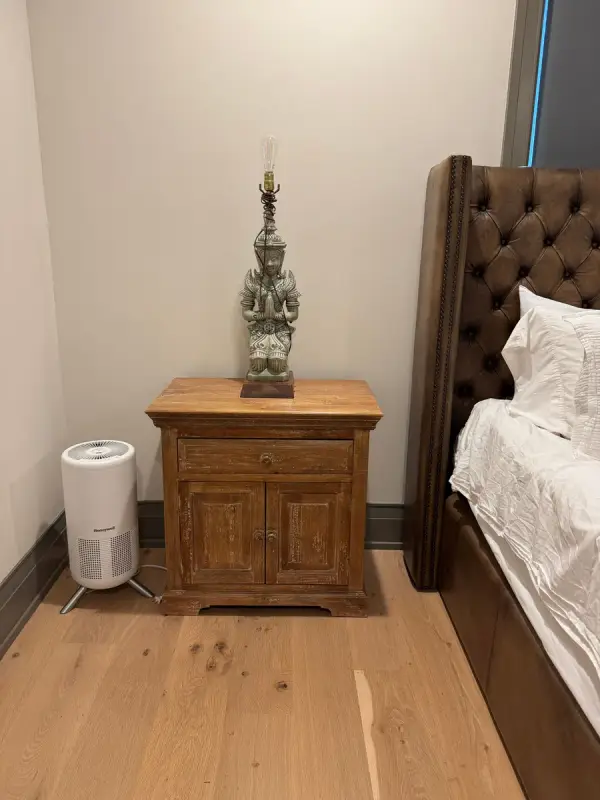 Wood nightstand against white walls and dark baseboard, Belle Meade, TN