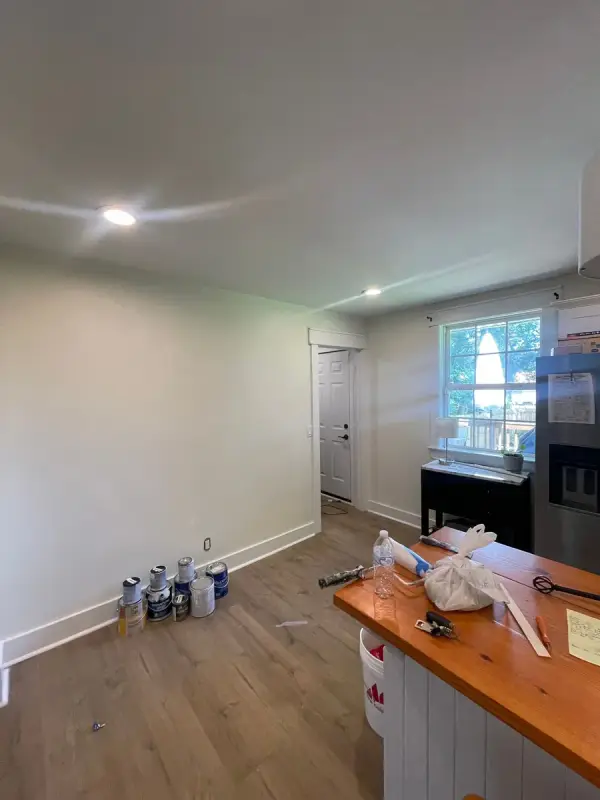 White-walled living area with paint cans on the floor, Belle Meade, TN