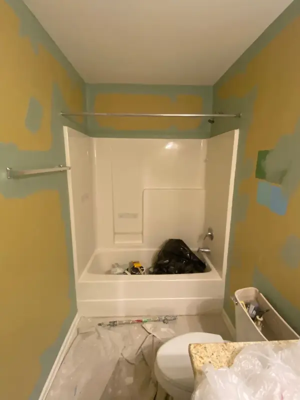 Yellow bathroom walls with green patches mid-project, Bellevue, TN