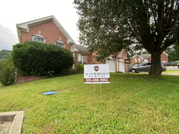 Brick house front with a yard sign on the lawn, Bellevue, TN