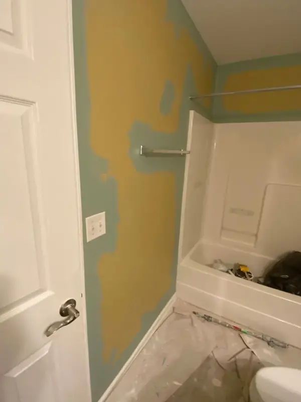 Yellow and green walls by the tub, floor under plastic, Bellevue, TN