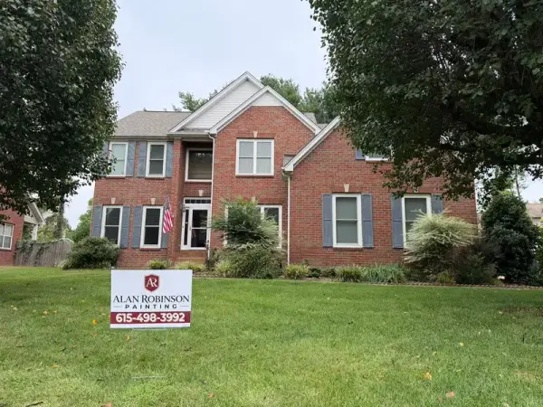 Brick house front with a yard sign on the lawn, Brentwood, TN