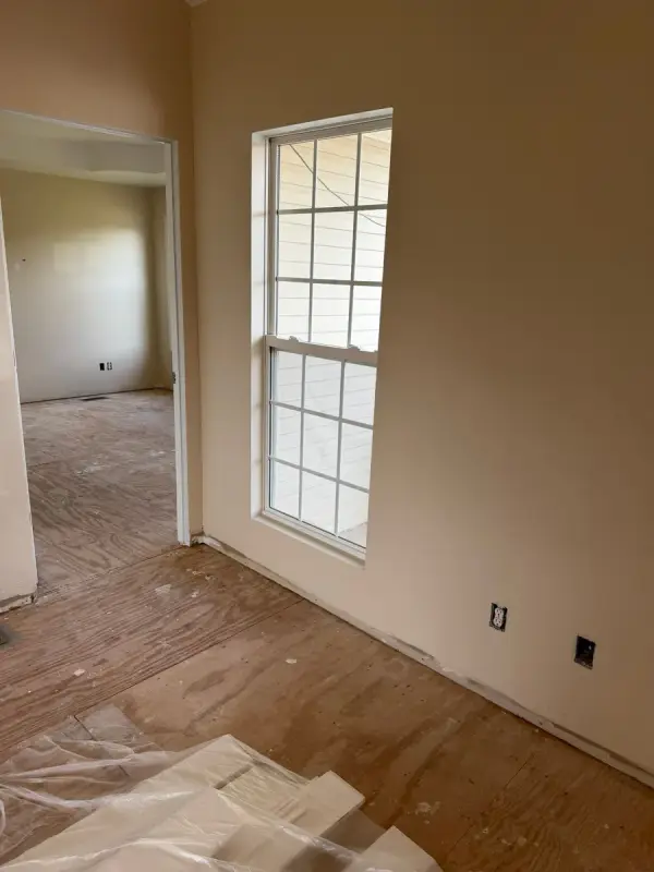 Tan room with a tall window and plastic on the floor, Pleasant View, TN