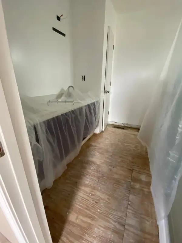 Narrow room with furniture under plastic, Pleasant View, TN