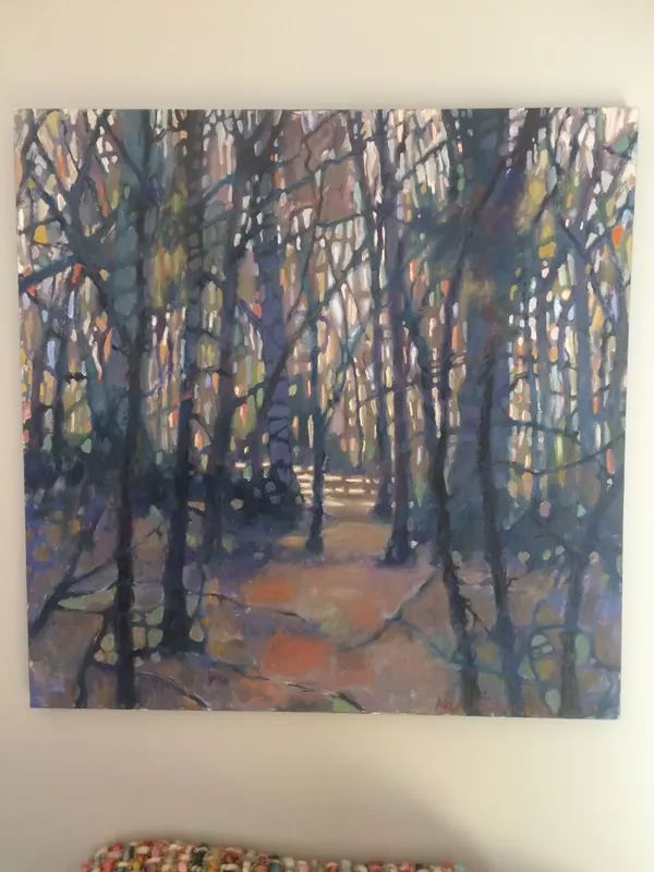 Slender trees in blue and amber crowding a winter woodland, by Alan Robinson