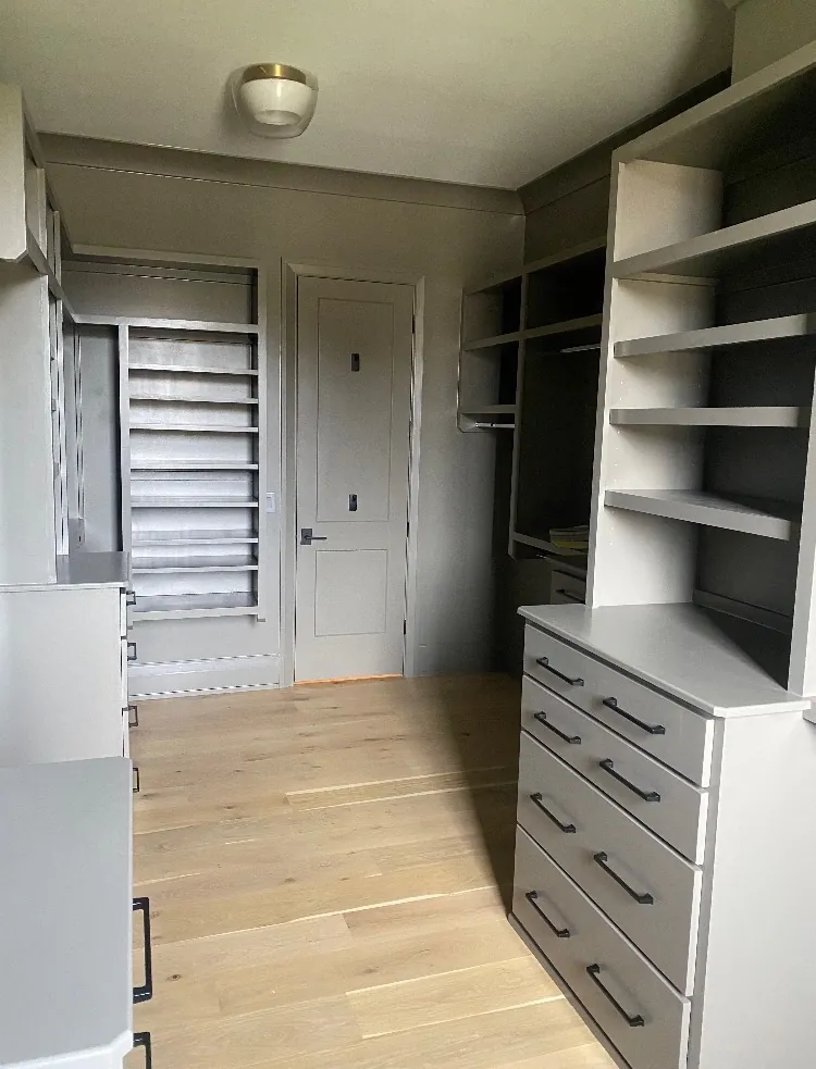 Walk-in closet built-ins with drawers and shelves painted soft gray, the kind of detail that shapes a Bellevue cabinet painting estimate