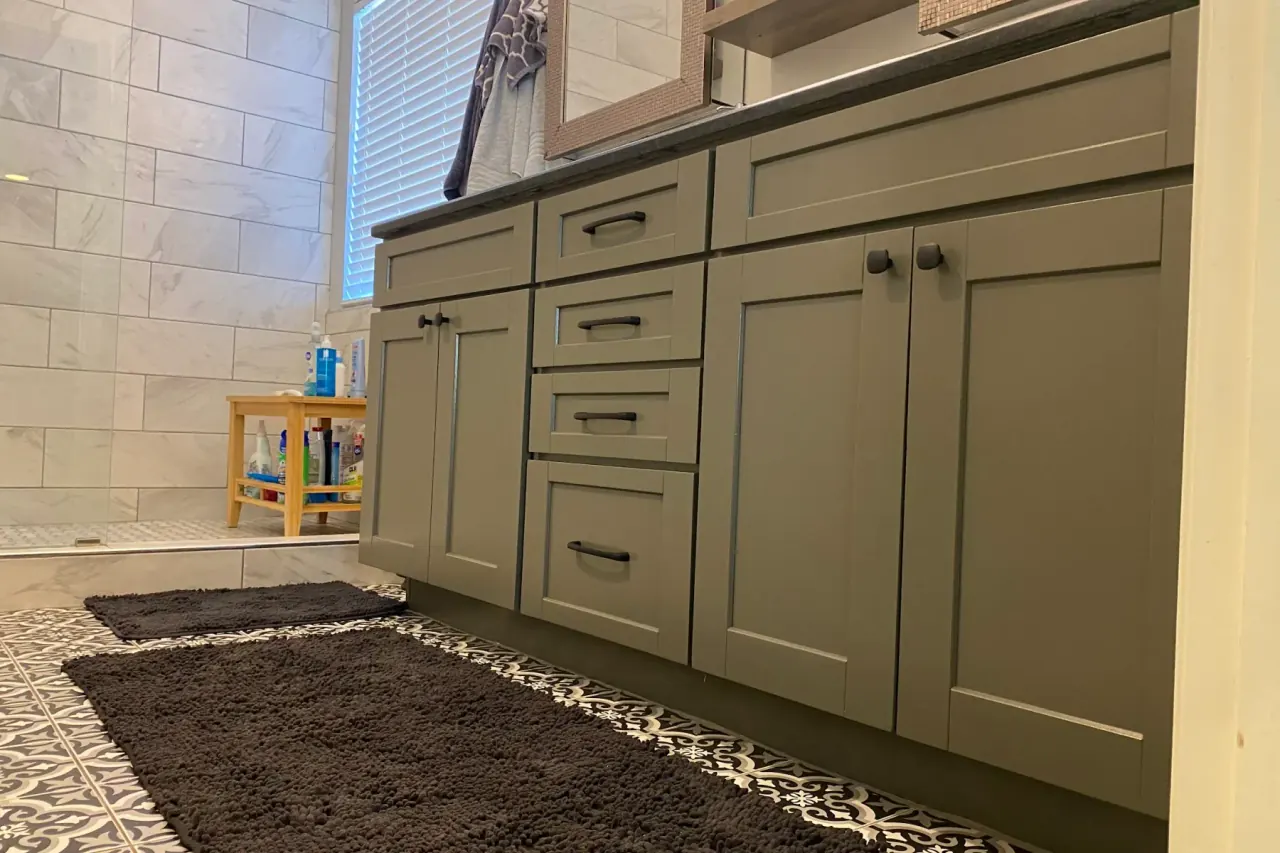 Bathroom vanity sprayed a soft sage green, part of the cabinet painting we do for Bellevue homes