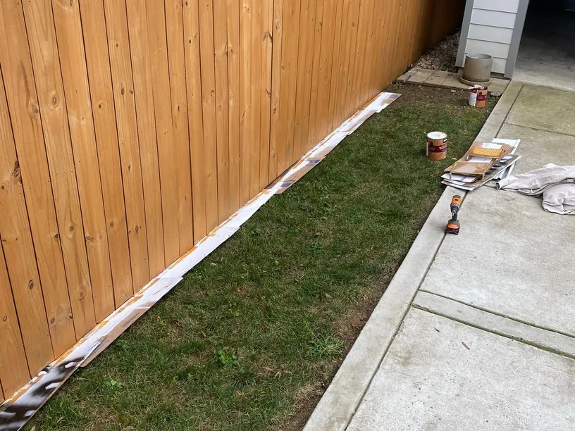 Long stained privacy fence along a side yard and garage drive, part of the fence staining we do for Fairview homes