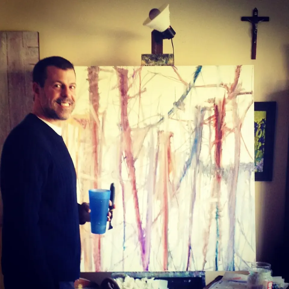 Alan Robinson in his studio beside one of his large oil paintings, part of the Robinson family business serving Bellevue