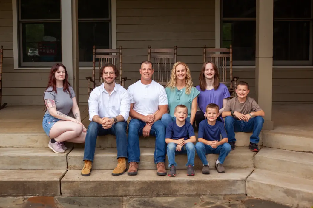 The Robinson family, including Alan, Beth and Sawyer, together on their front porch, part of the Robinson family business serving Bellevue