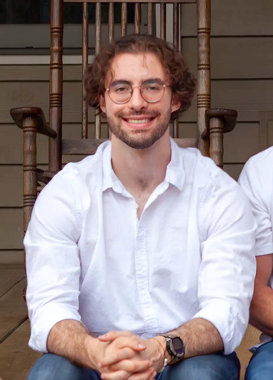 Sawyer Robinson, Alan's son, smiling on the family's front porch, part of the Robinson family business serving Bellevue