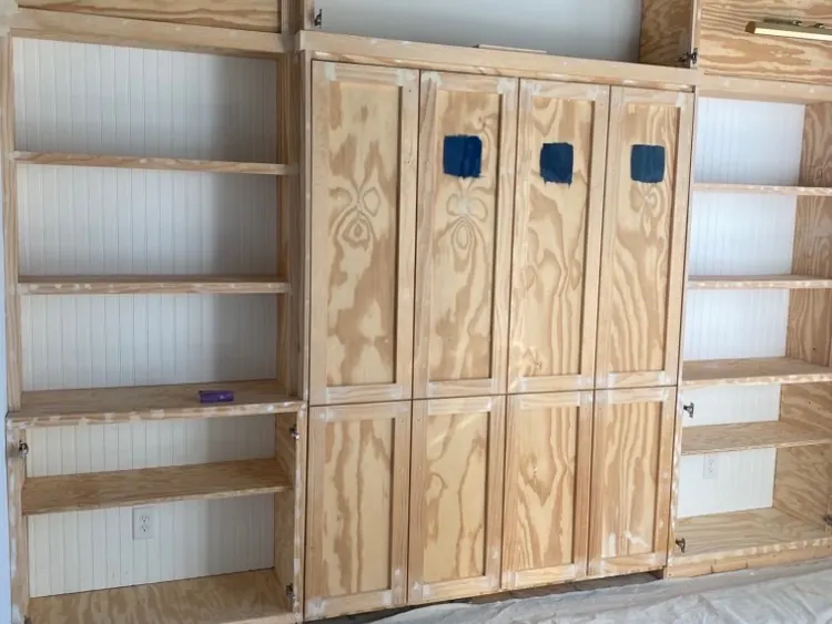 Built-in cabinets and shelving in bare wood, open grain showing, before priming, cabinet painting for a Belle Meade home