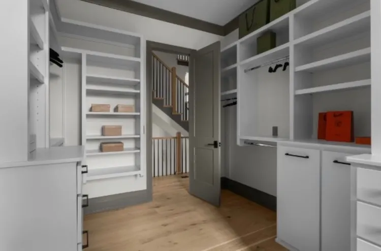 Custom closet built-ins with drawers and shelving painted light gray, one of our cabinet painting projects for Bellevue homes