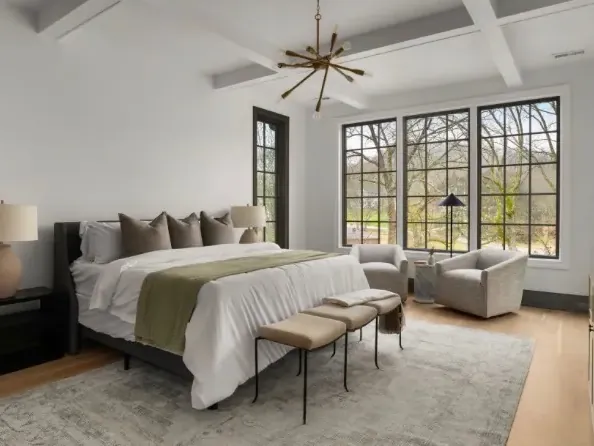Primary bedroom with exposed beams and dark painted trim, one of our interior painting projects for Franklin homes