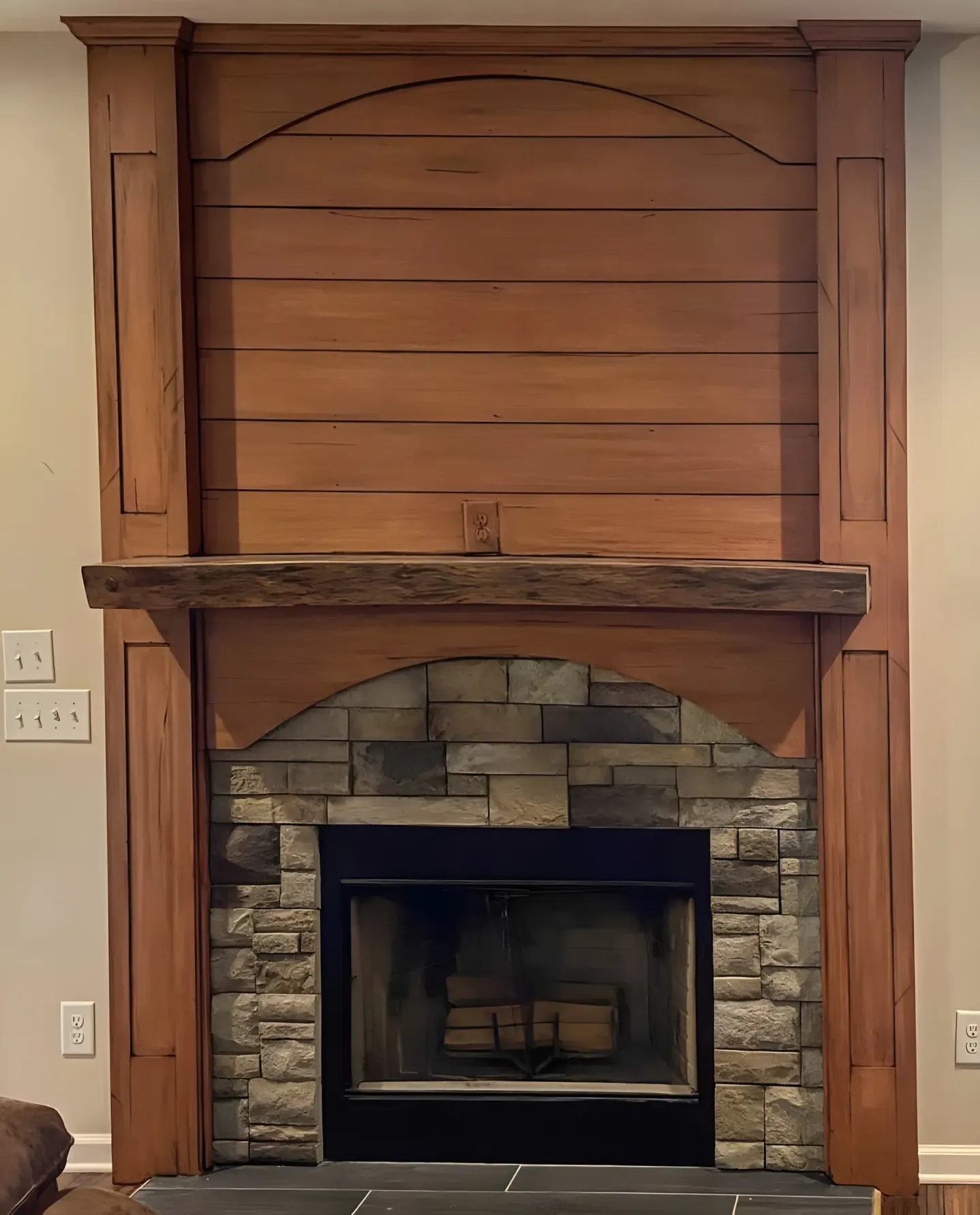 Wood-tone fireplace mantel and overmantel finished by hand above a stone firebox, one of our interior painting projects for Belle Meade homes