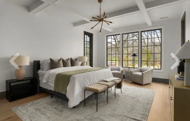 Master bedroom with exposed beams and dark trim — Nashville luxury interior painting