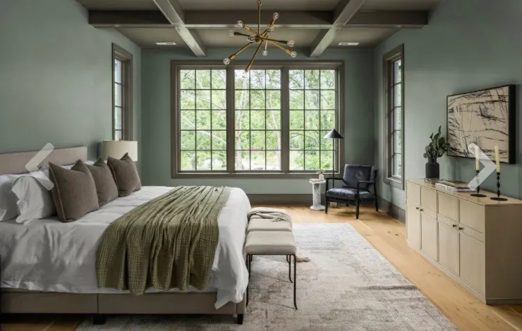 Sage green bedroom with coffered ceiling and dark trim accents by Alan Robinson
