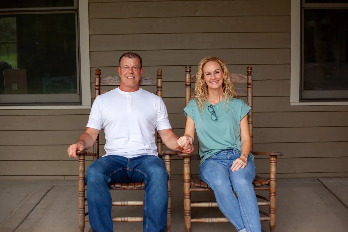 Alan and Beth Robinson in rocking chairs on their front porch, part of the Robinson family business serving Bellevue