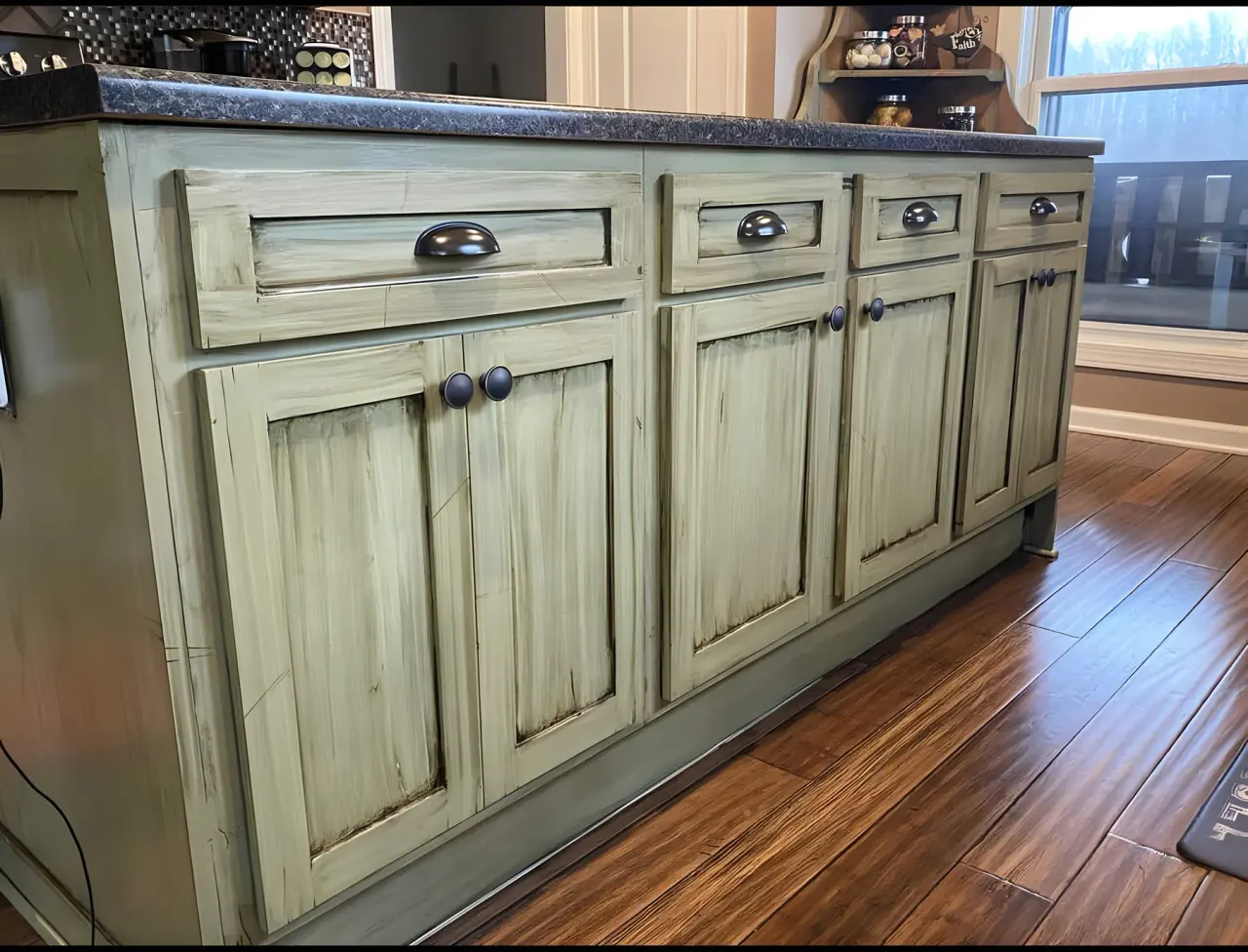 Island cabinetry finished in a hand-glazed sage green with softly worn edges, one of our cabinet painting projects for Bellevue homes