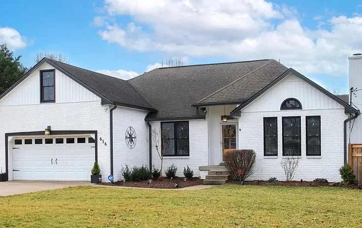 Brick ranch painted white with black trim and black window frames, exterior painting for Bellevue homes