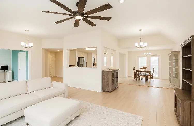 Open-plan living and dining area with a vaulted ceiling and fresh paint, interior painting for Bellevue homes