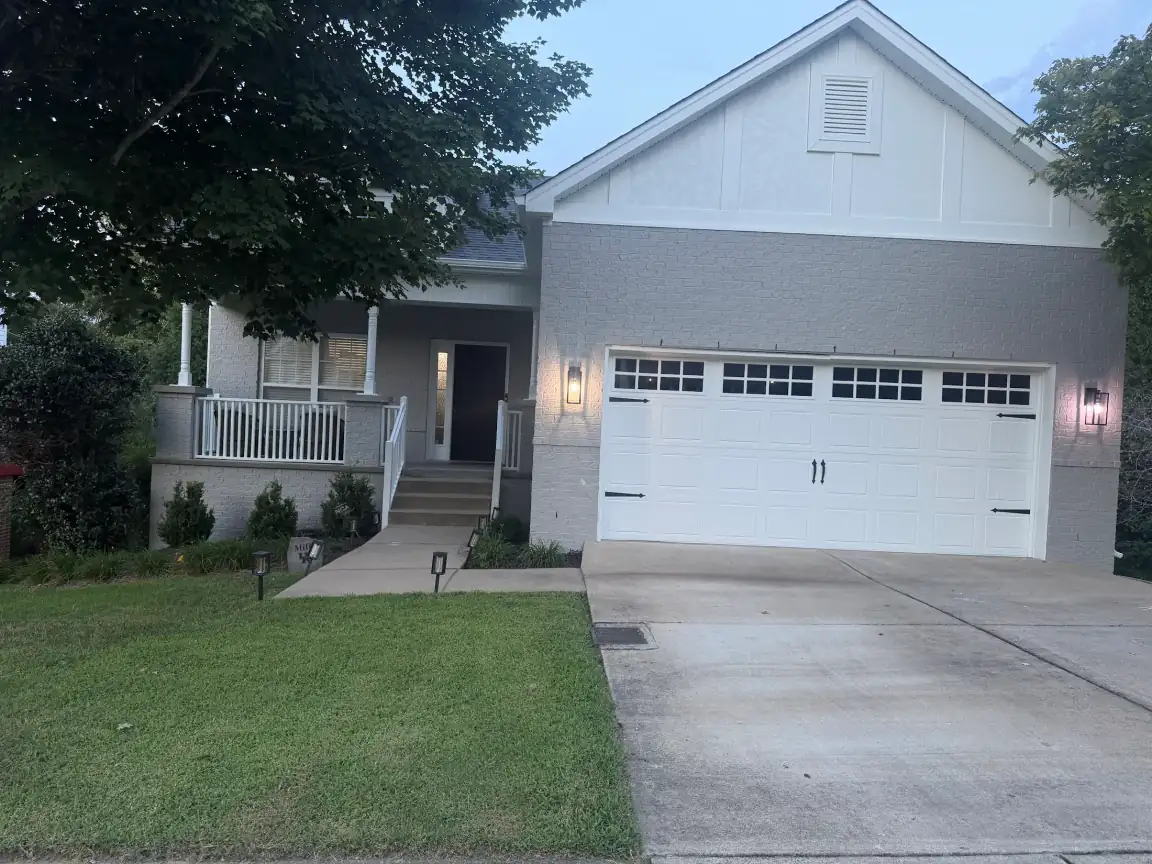Caleb M.'s gray-painted brick with a white board-and-batten gable, part of the exterior painting we do for Bellevue homes