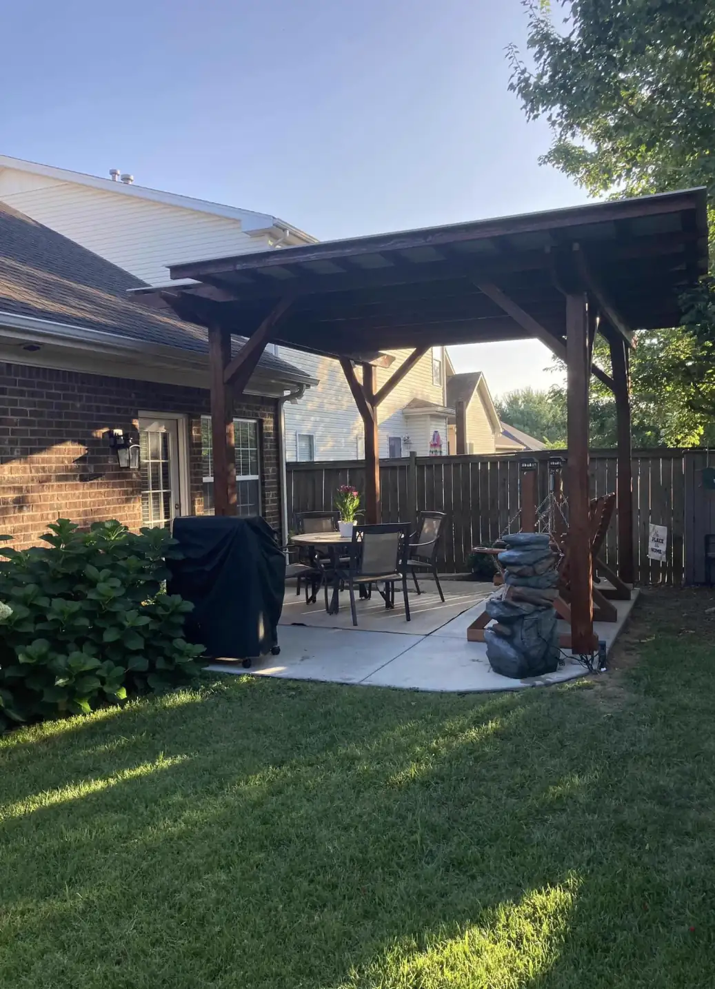 John Z.'s covered pergola, freshly stained, with hanging swings, shared with a Facebook review of our exterior wood staining